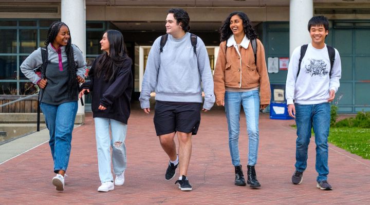 a group of students walking and smiling together