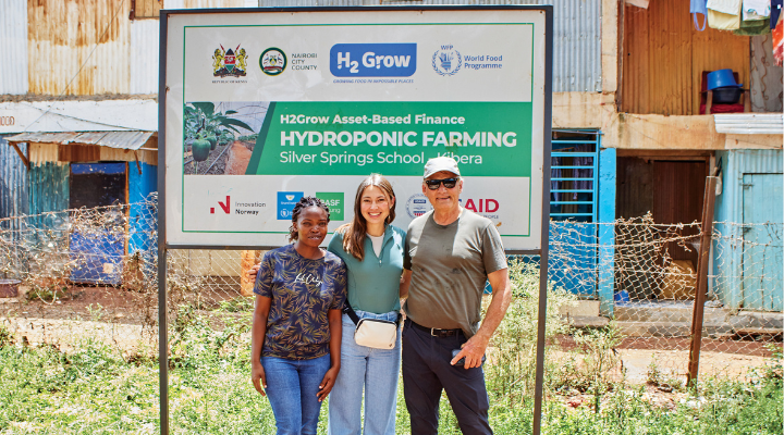 group picture in from of hydroponic farm