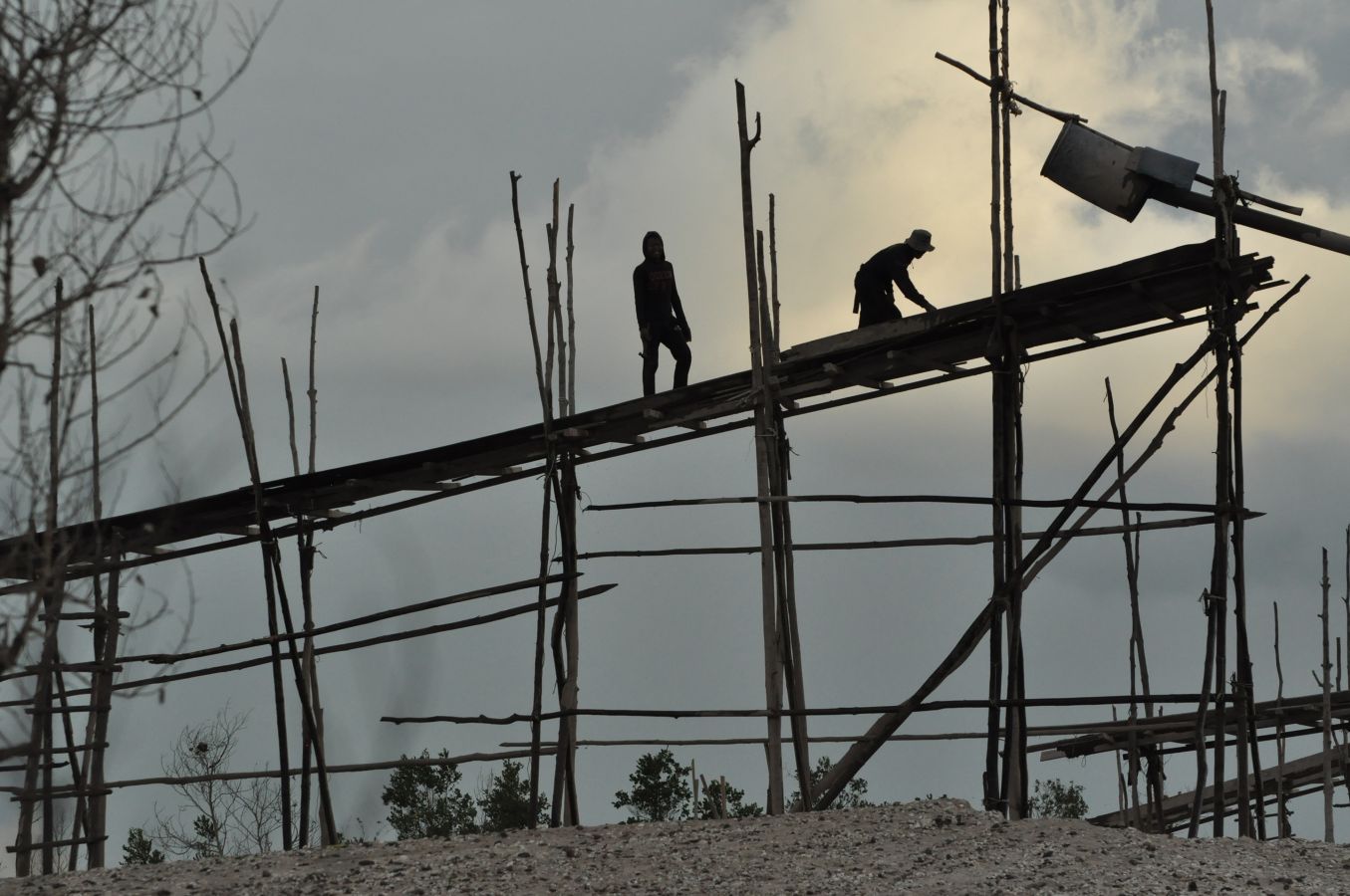 Miners preparing a wooden sluice structure